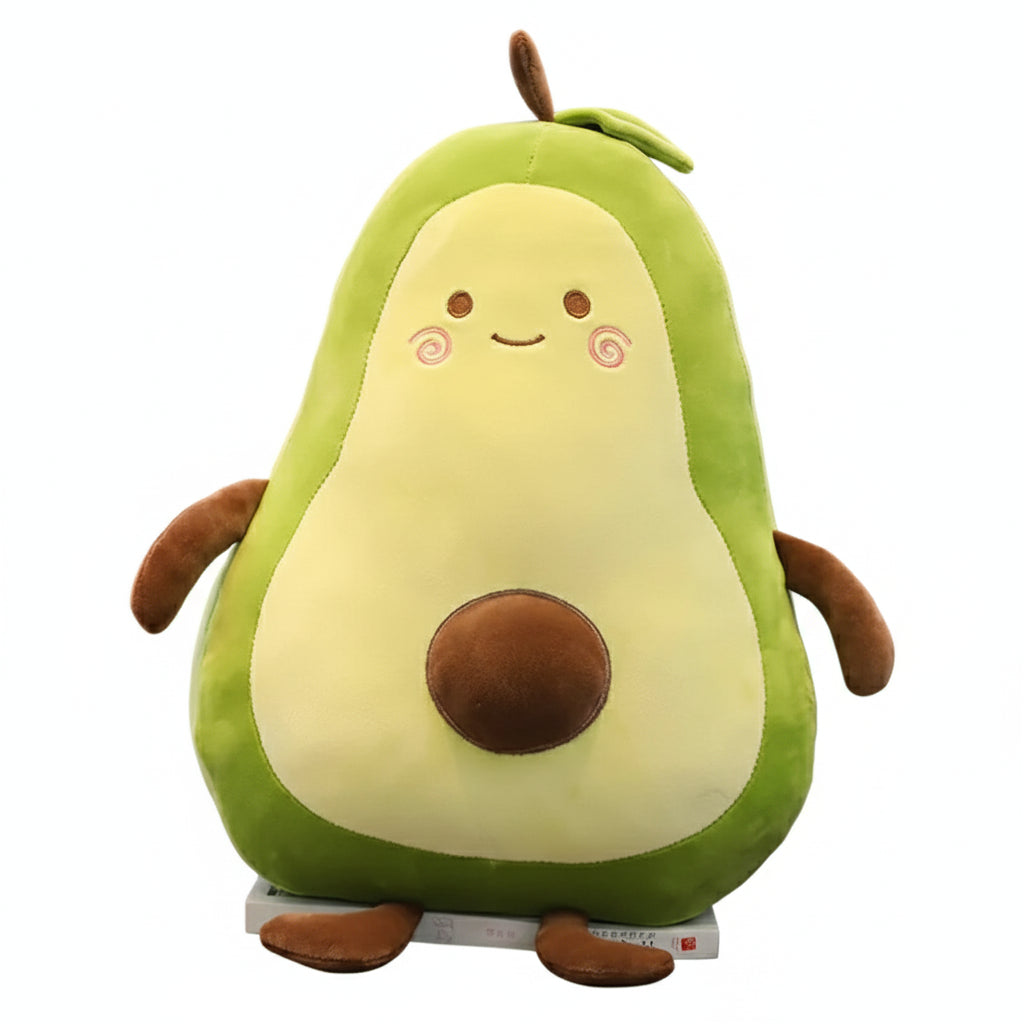 Plush avocado toy with a smiling face on a book
